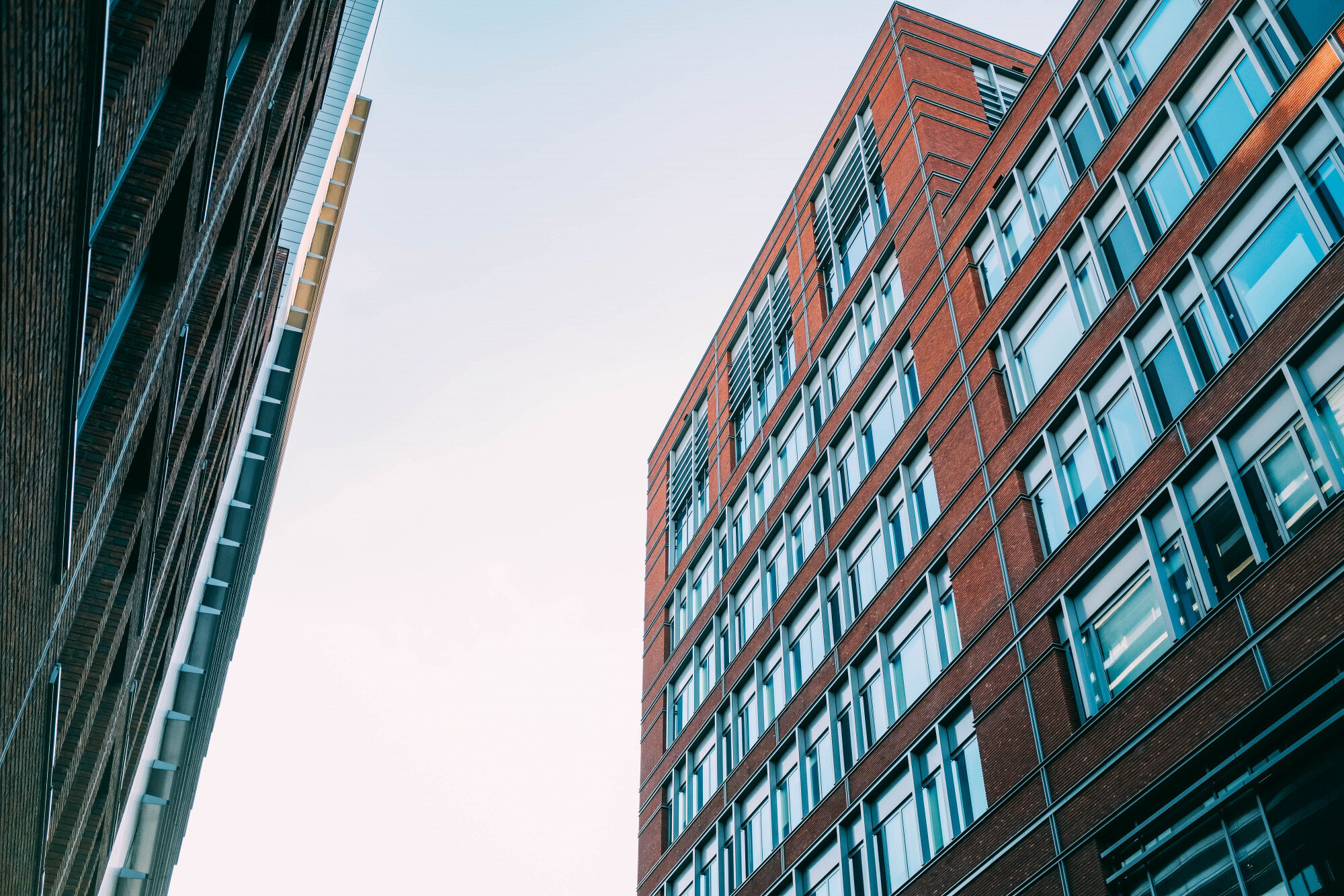 low-angle-shot-concrete-apartment-buildings-with-lot-windows-1